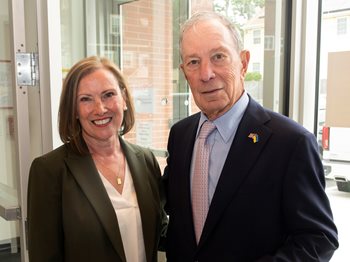 East Cambridge Savings Bank President and CEO Gilda Nogueira stands with Michael Bloomberg at the Library’s dedication ceremony.