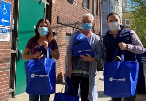 Employees bringing donations to East End House.