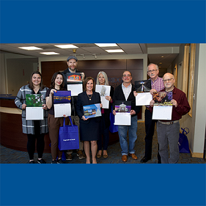 Calendar photo contest winners join East Cambridge Savings Bank President and CEO Gilda Nogueira in the Bank’s Main Office reception area. Left to right (and their photo/month they are featured in the calendar): Emily Murray (May), Katy Rogers (June), Sean Sullivan (September), Gilda Nogueira, Bank’s President and CEO, Karen Walker (February), Daniel Howard (January), Sean Riley (March), Stan Eichner (December). 