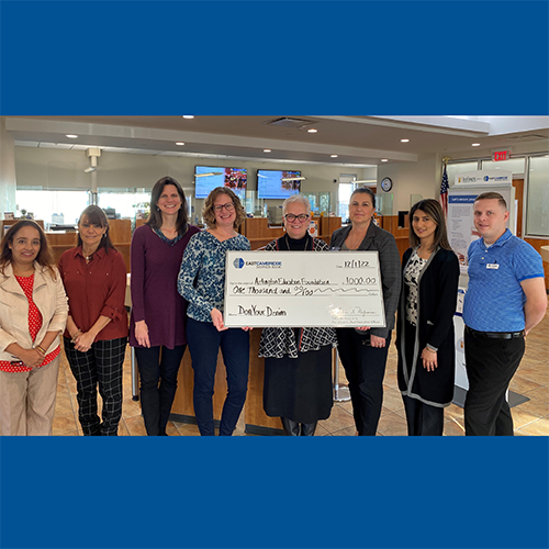 A group of Bank employees standing with representatives from the Arlington Education Foundation. They are holding a ceremonial check for $1,000, which is the money contributed by Bank employees to benefit Arlington Education Foundation. 