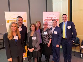 A group of Bank employees attending the Triangle, Inc. 50th Anniversary celebration and fundraiser on April 28, 2022 at the John F. Kennedy Presidential Library and Museum.