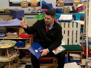 Bank employee reading to children at the Morse School in Cambridge